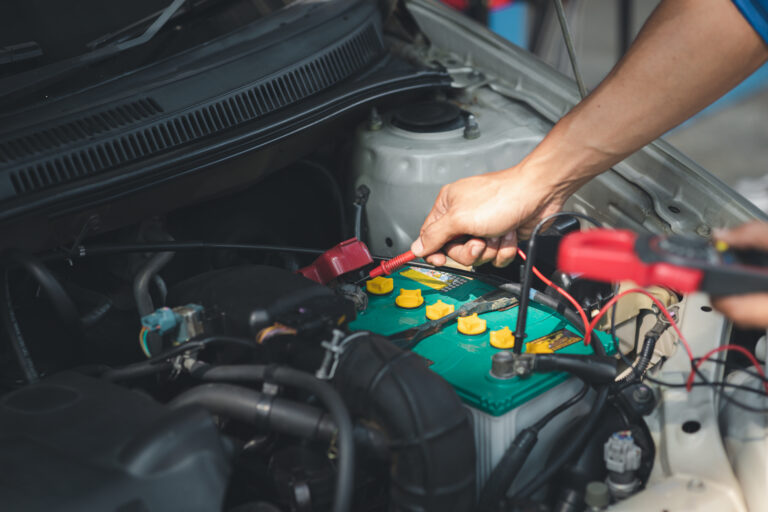 Professional mechanic checking customer's car's electrical syste